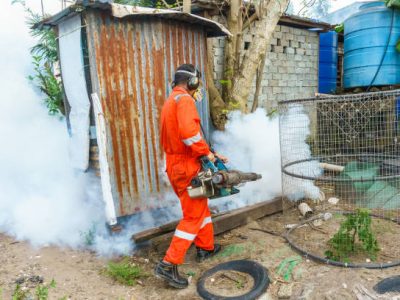 Kota Kinabalu Sabah, Malaysia - Apr  08, 2017: A man use fumigation mosquitoes machine for kill mosquito carrier of Zika virus and dengue fever prevention outbreak.