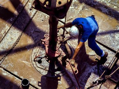 Drilling rig workers preparing to make a connection during drilling operation.